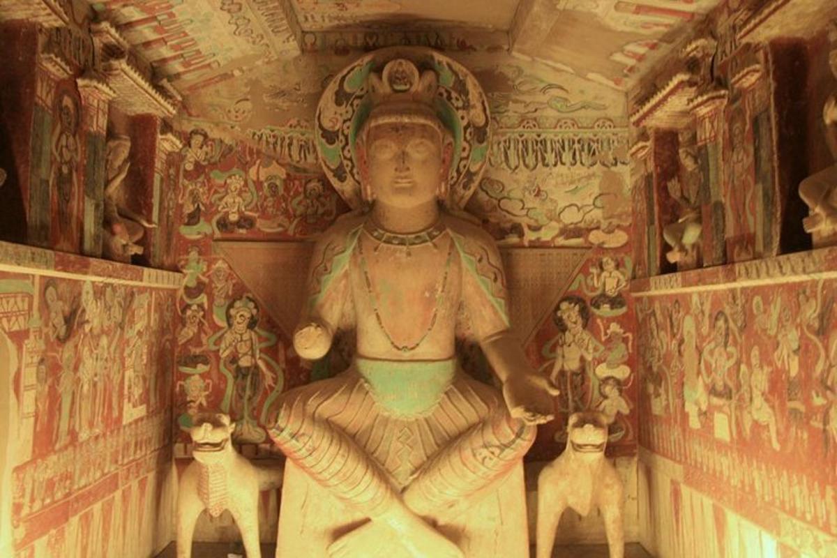 a statue in a room with paintings on the wall