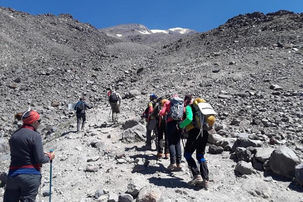 a group of people walking on a rocky mountain