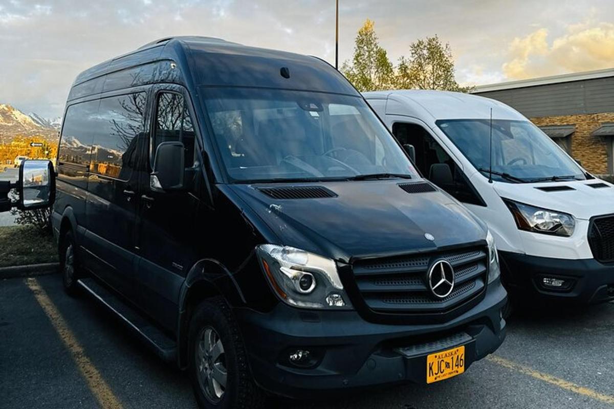 two delivery vans parked in a parking lot