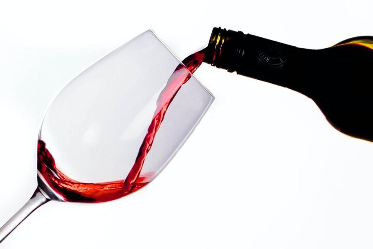 steklenica rdečega vina, ki se nalije v kozarec