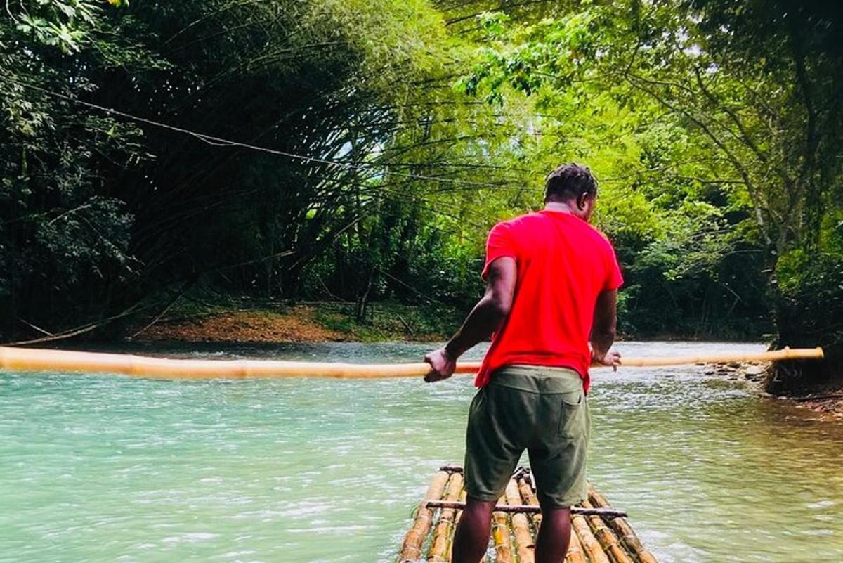 a man holding a pole on a raft in the water
