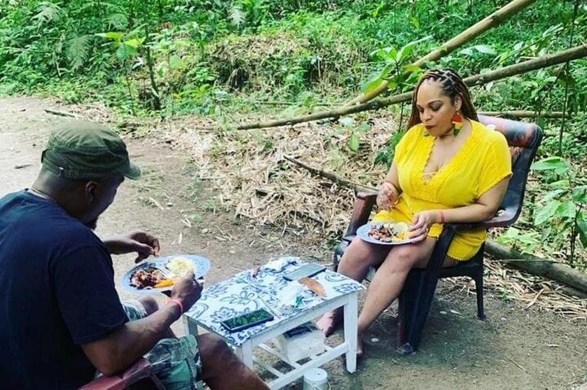 a man and a woman sitting in a chair eating food