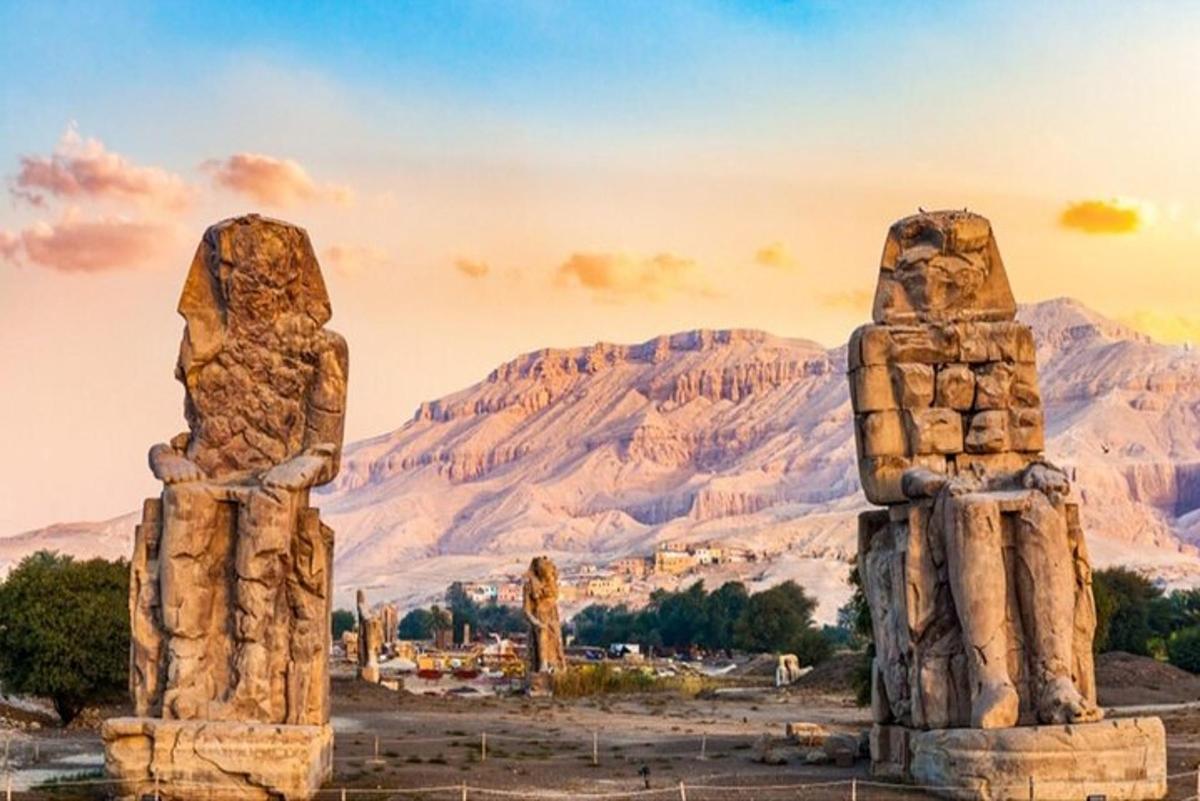 a group of statues in front of a mountain