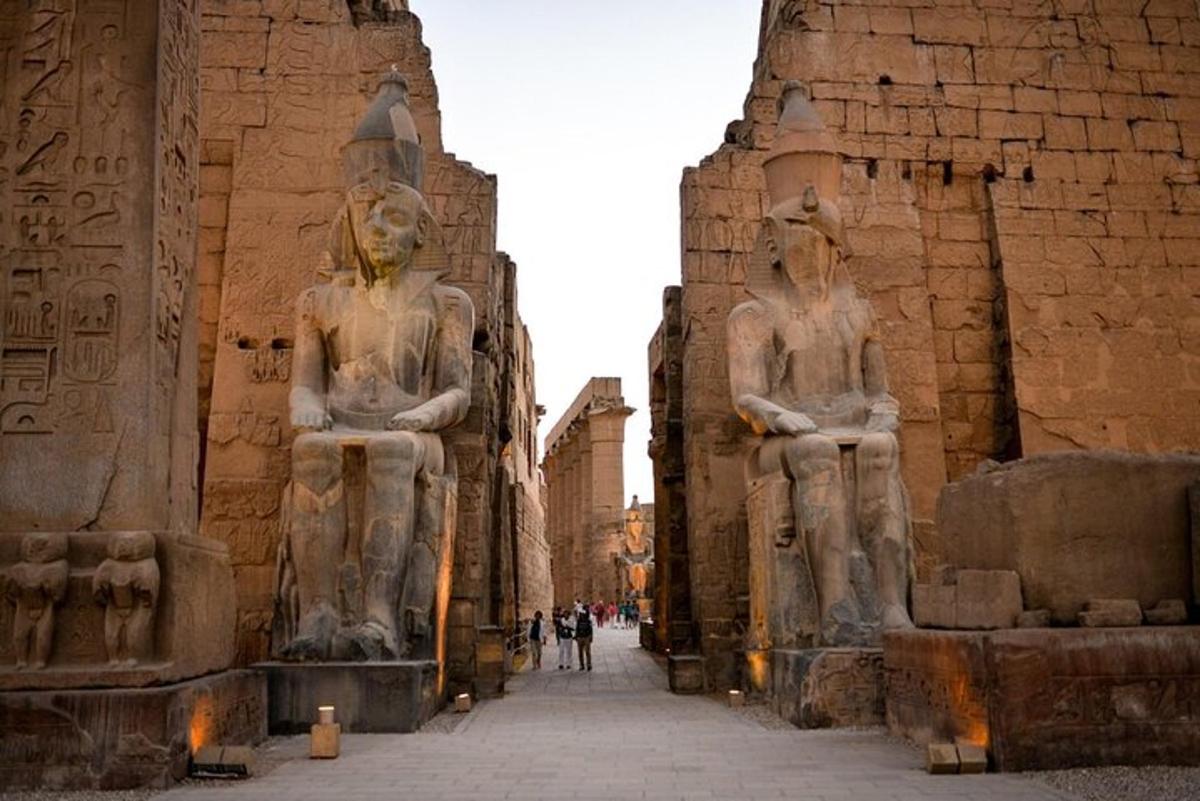 two large statues of people in an ancient building