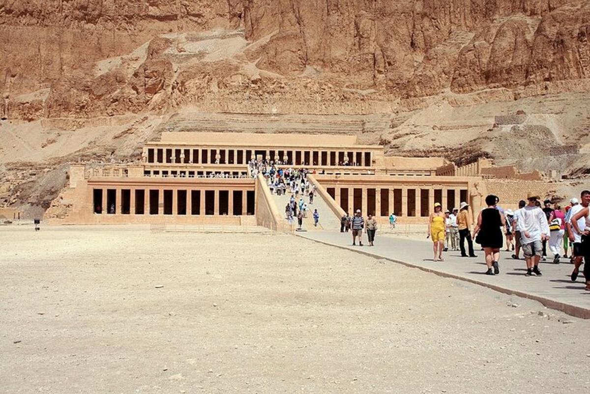 a group of people walking in front of a building