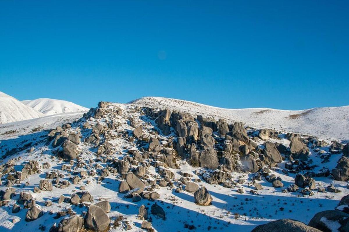 a snowy mountain with rocks and snow on it