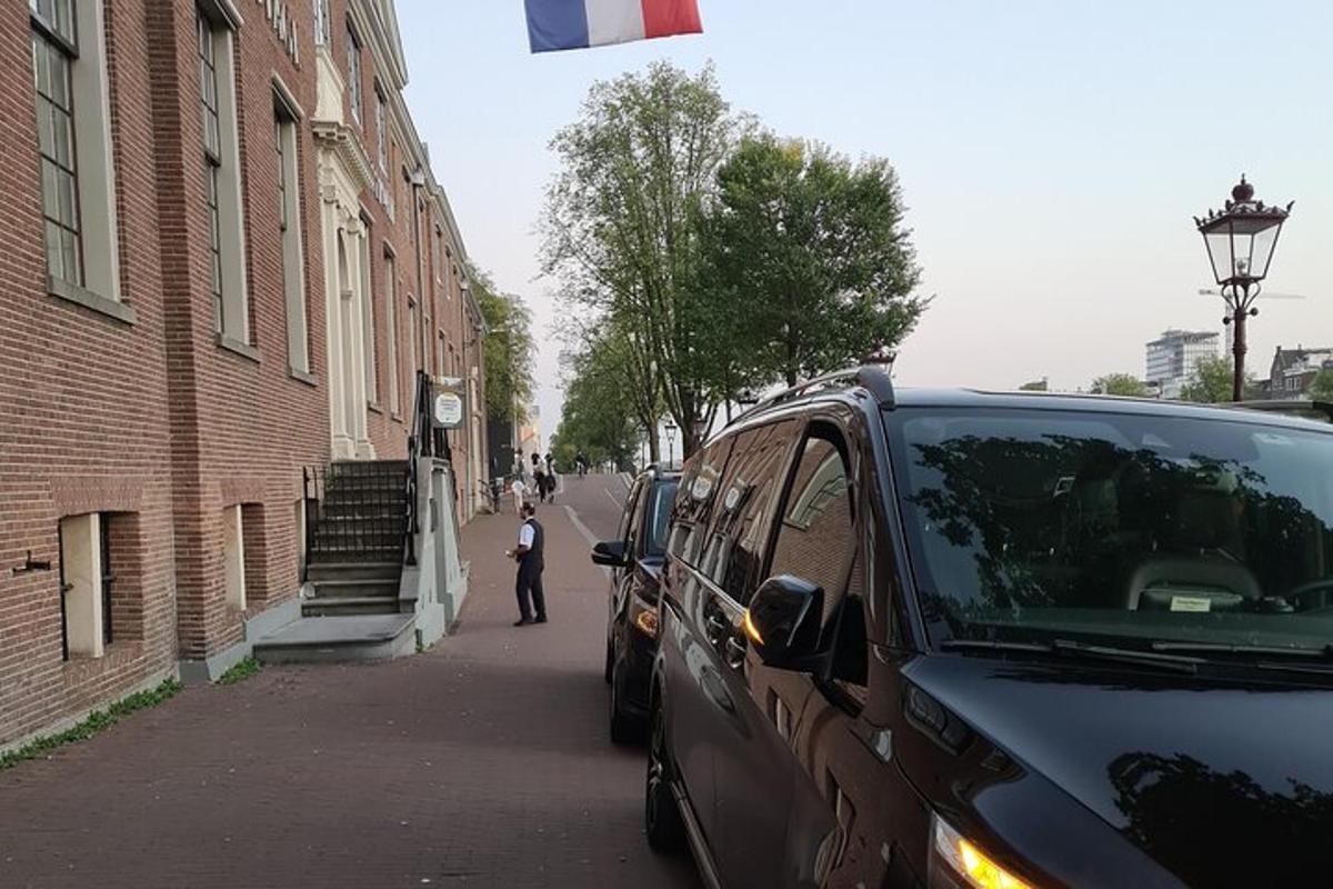 a man is walking down a street next to a van