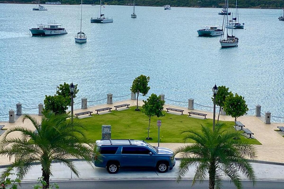 a blue van parked on a road near a body of water