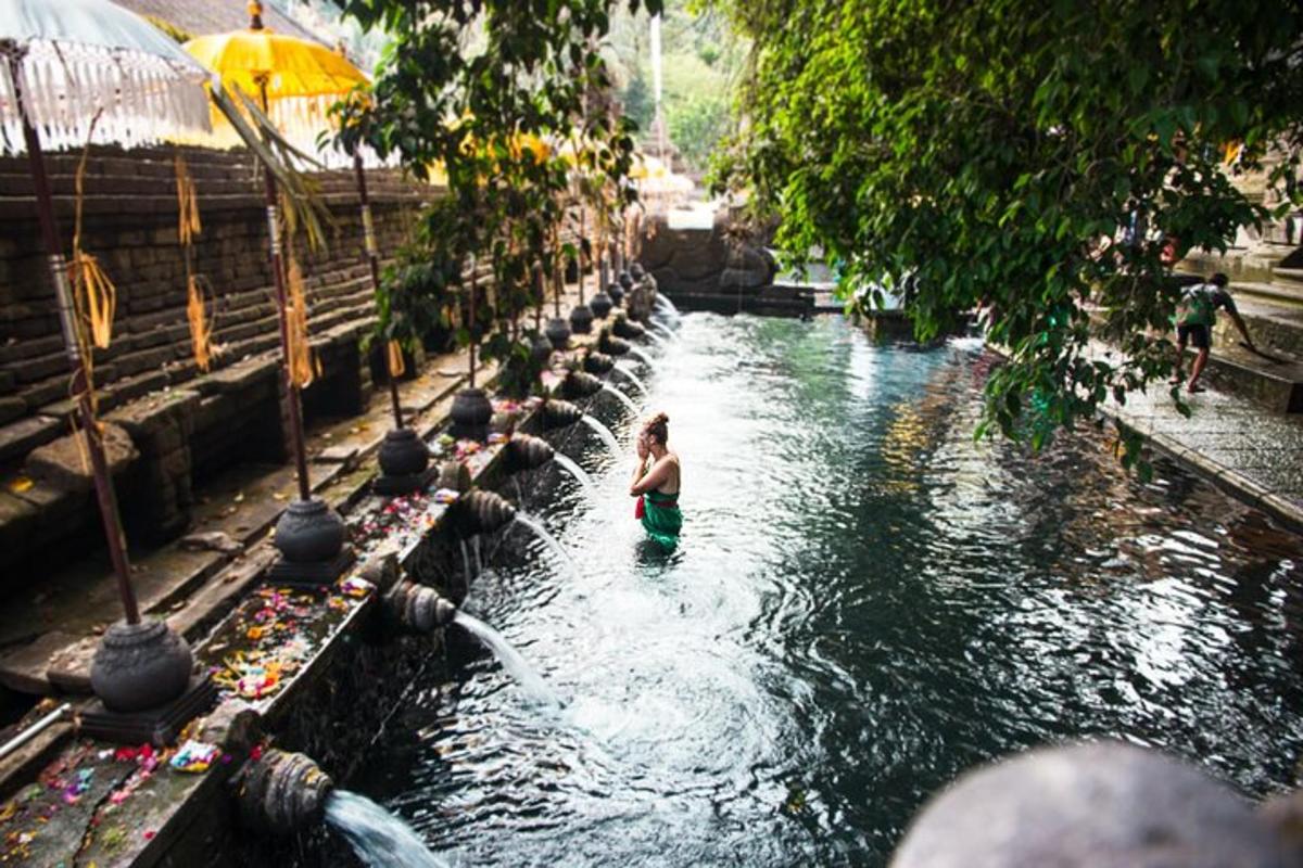 a woman standing in the water at a water park