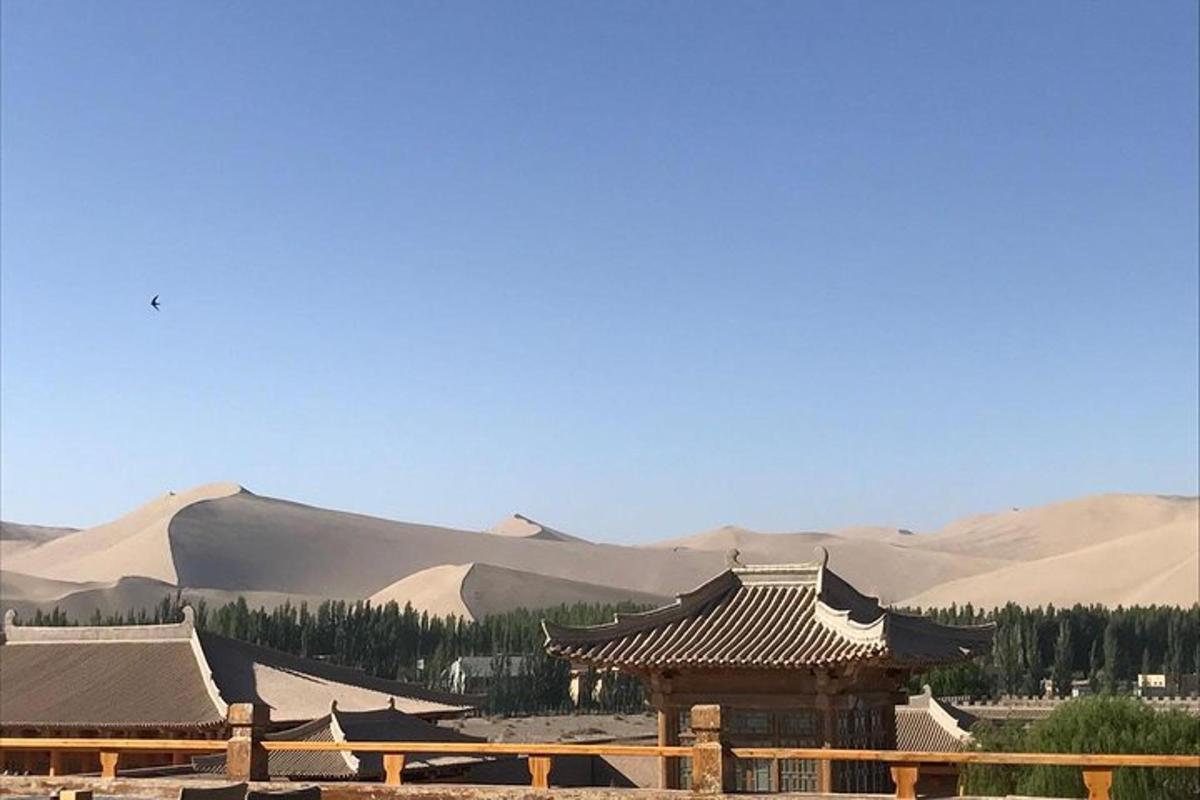 a chinese building with mountains in the background