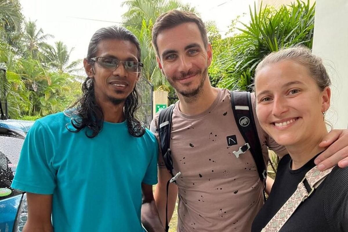 two men and a woman posing for a picture
