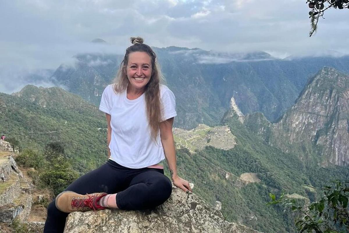 seorang wanita duduk di atas gunung