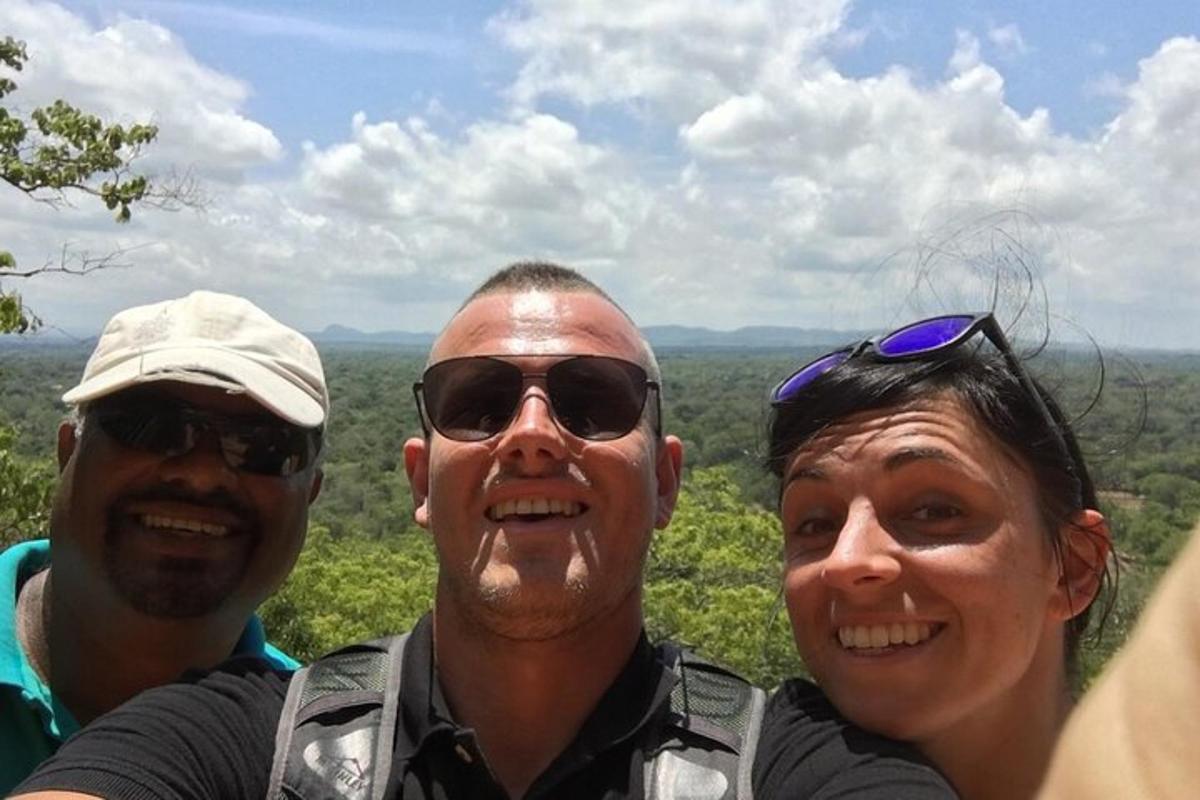 two men and a woman posing for a picture