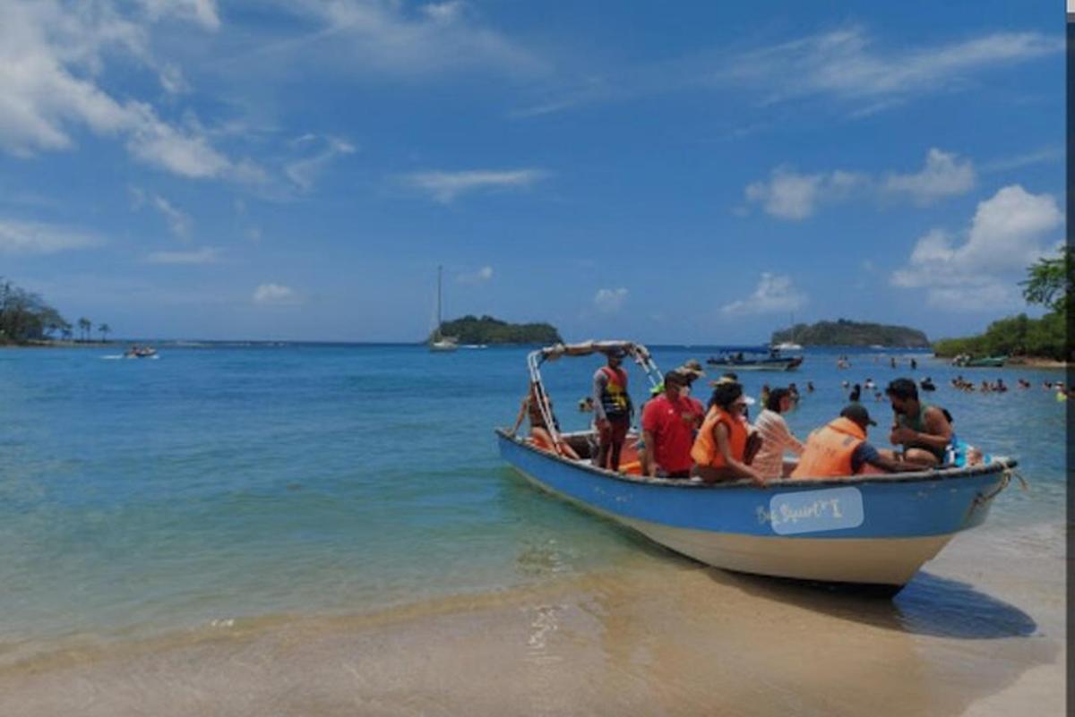 sekelompok orang di perahu biru di pantai