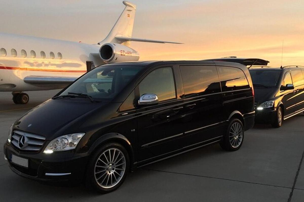 a black van parked next to an airplane