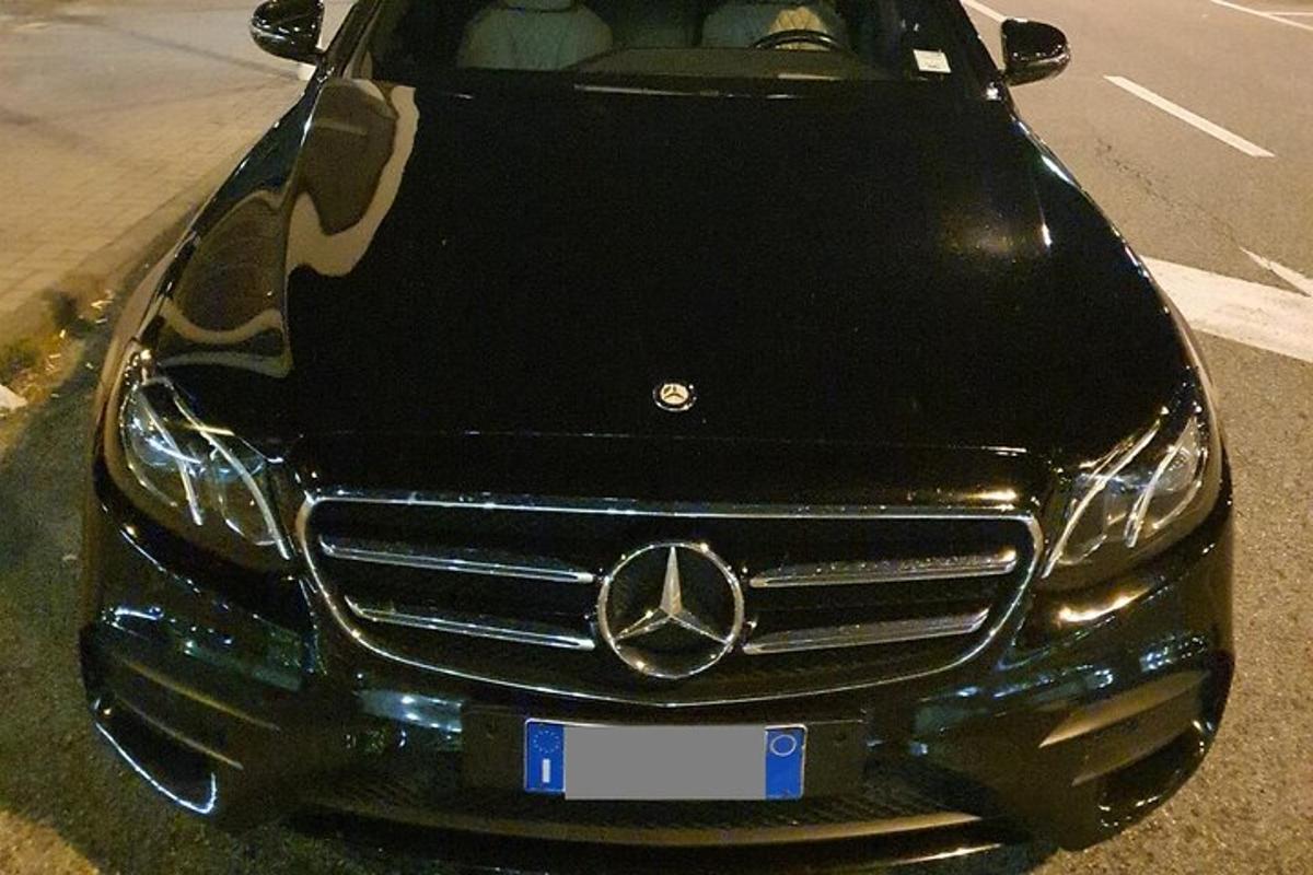 a mercedes benz car parked on the side of the road