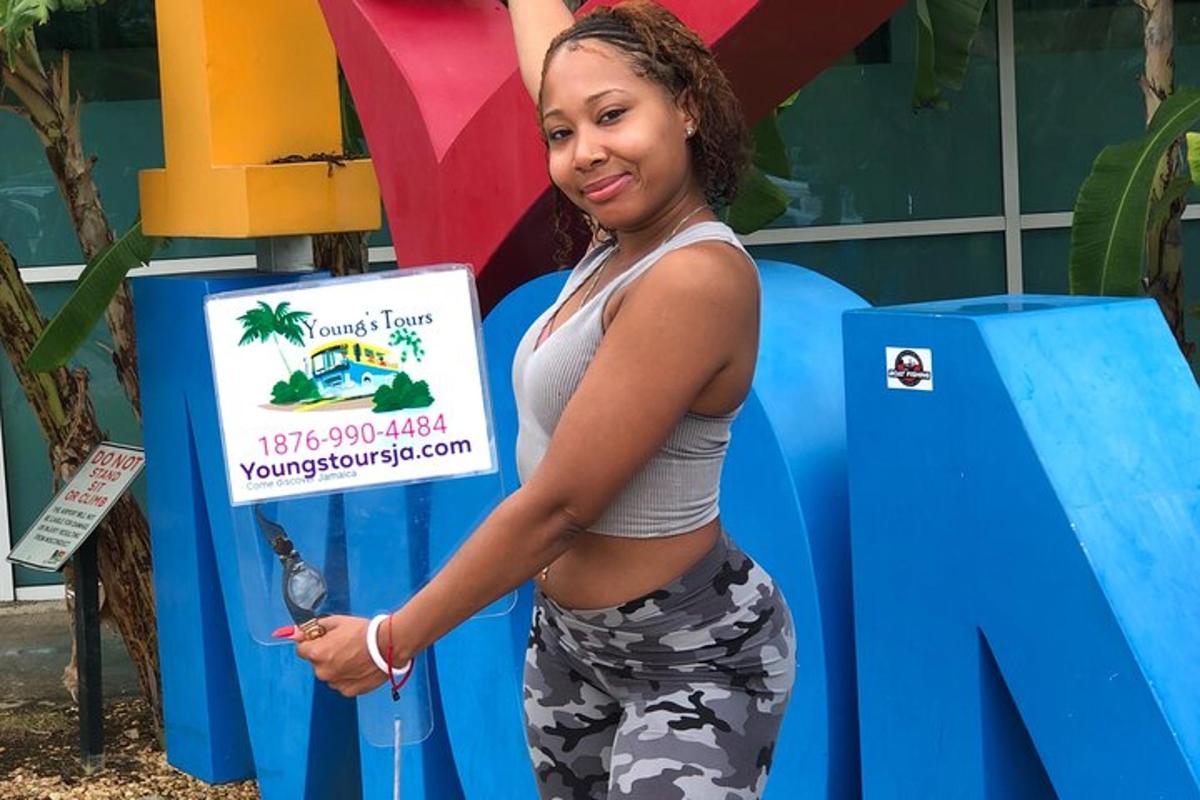 a woman standing next to a sign with a bird