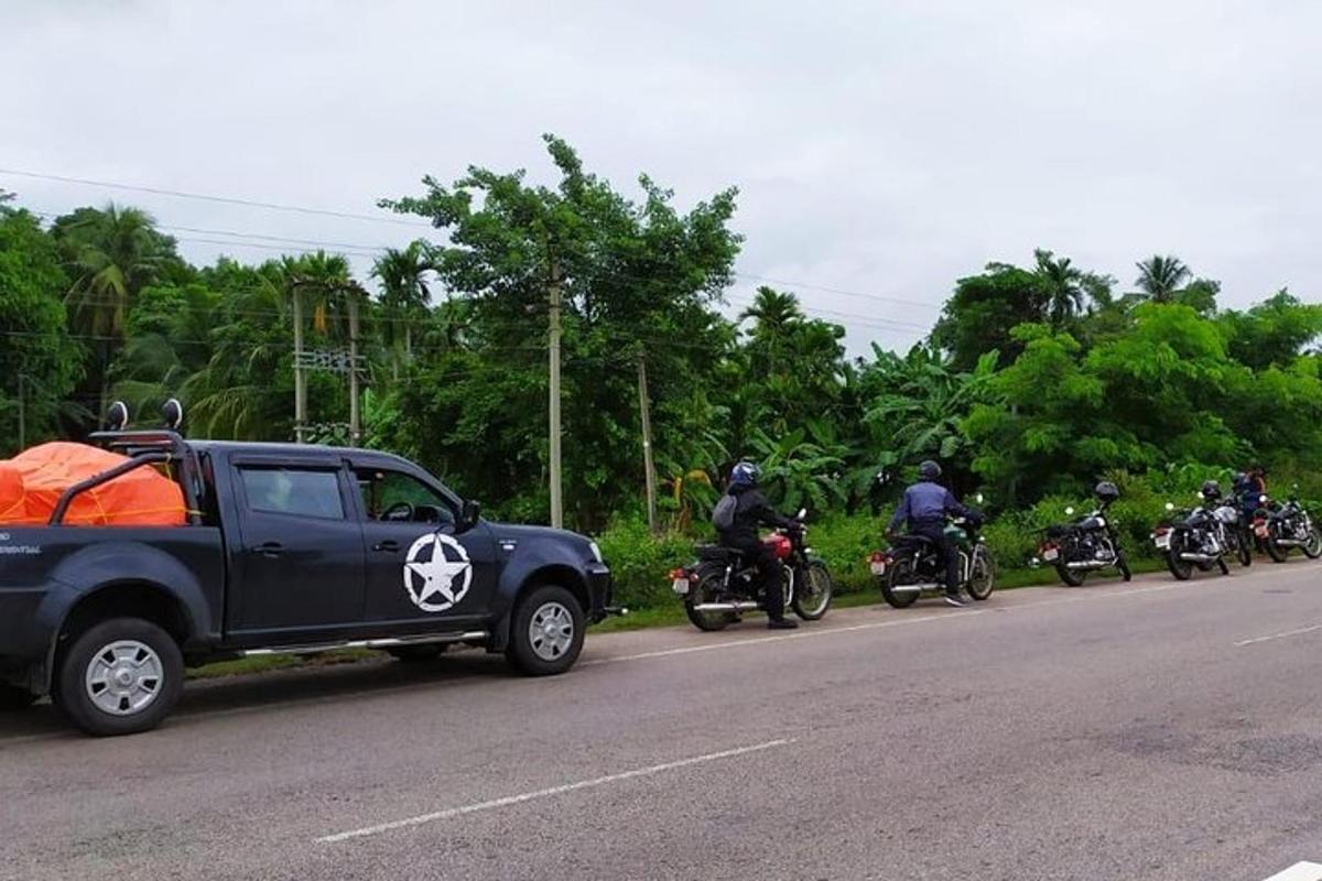 a group of motorcyclists are parked on the side of a road