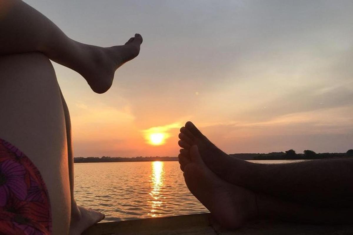 a person with their feet up in front of a body of water