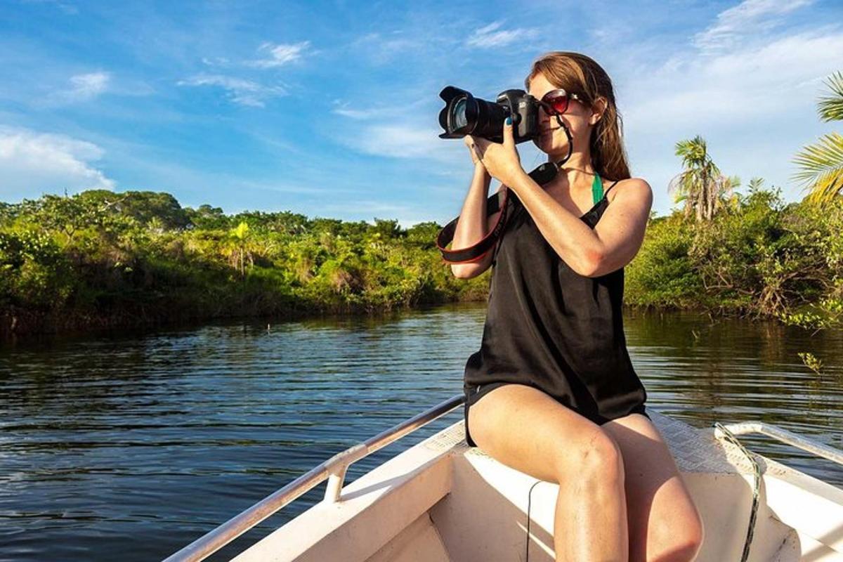 a woman sitting on a boat taking a picture