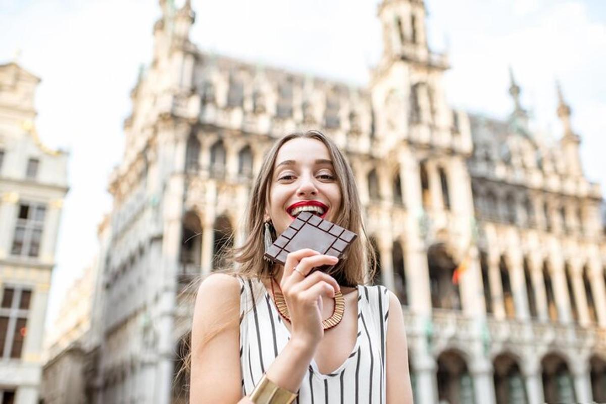 a woman holding up a cell phone in front of a building