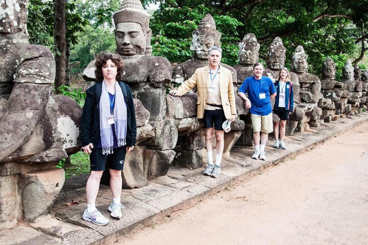 a group of people walking in front of a statue