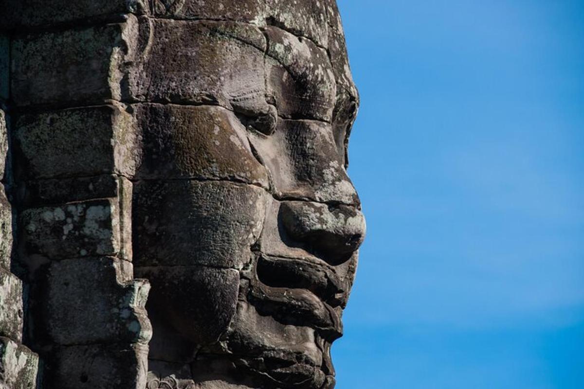 a statue of a face on the side of a building