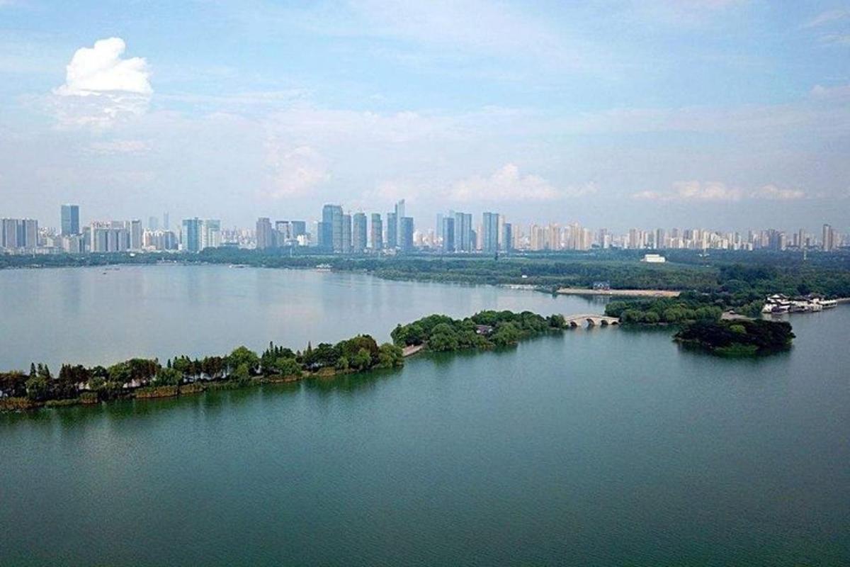 a large body of water with a city in the background