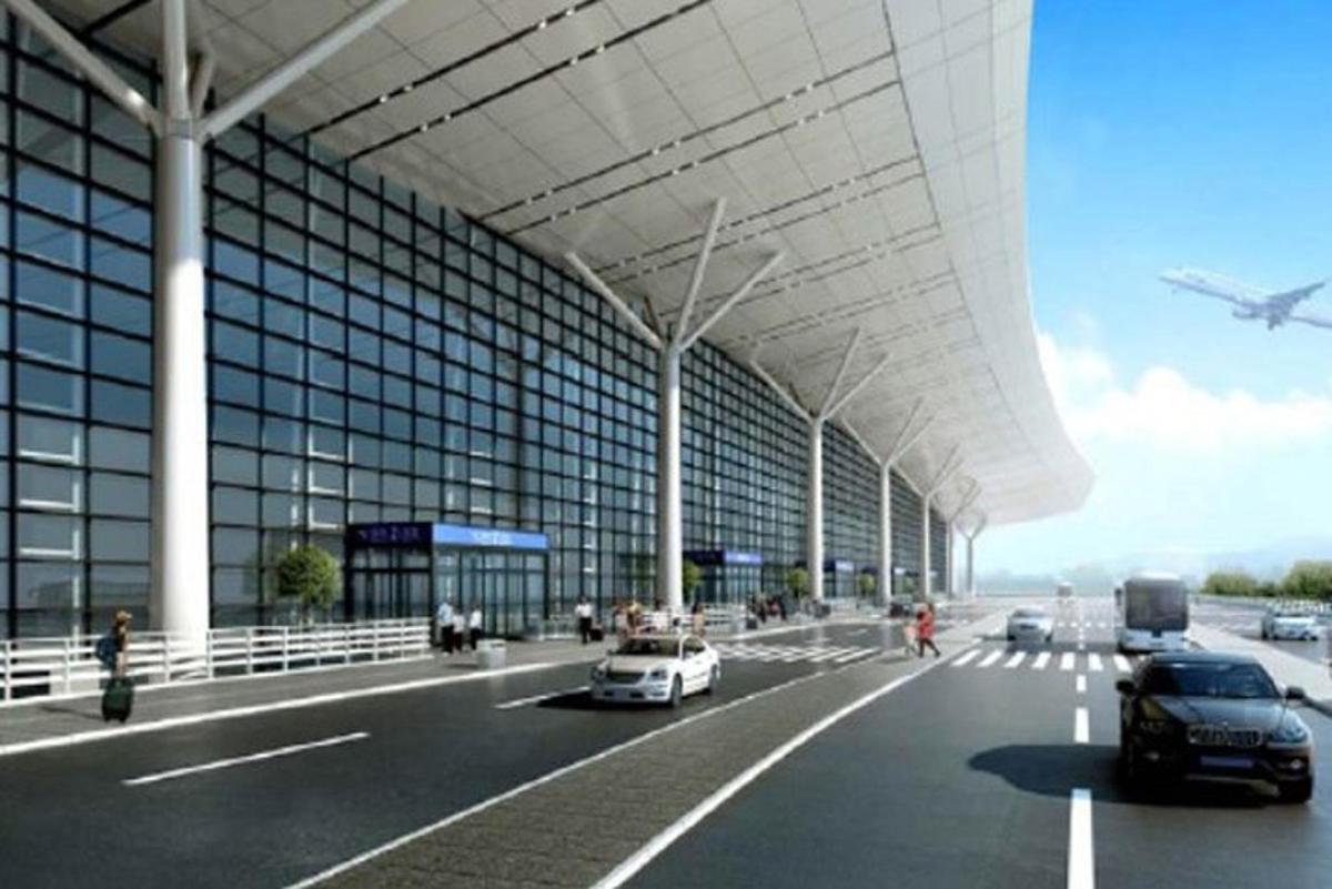 an airport with cars parked in front of a building