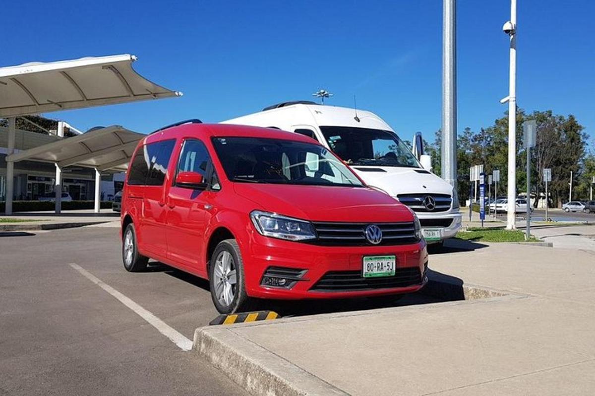 a red van is parked in a parking lot