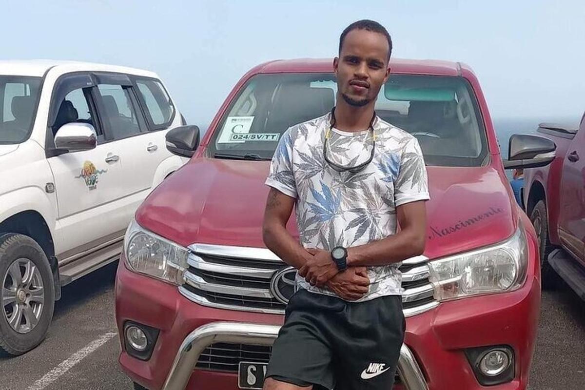 a man standing in front of a red truck