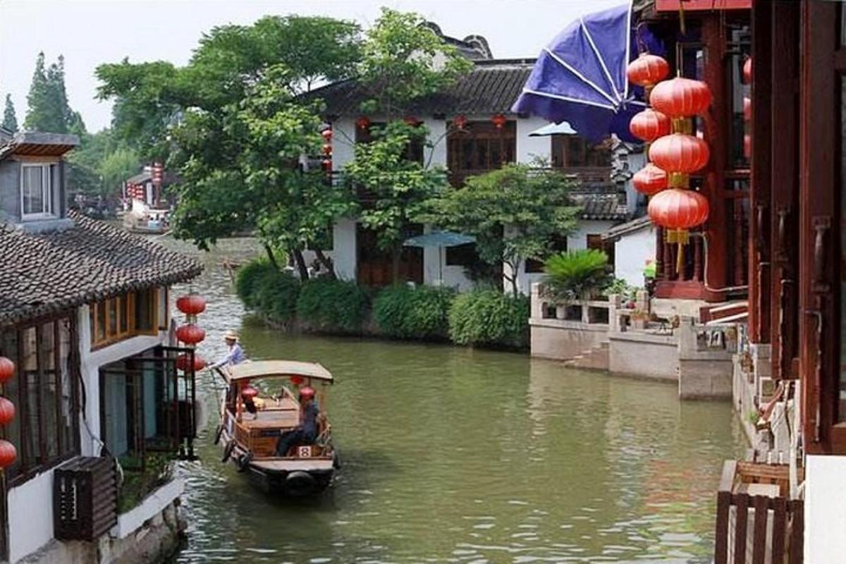 a boat on a river in a city with buildings