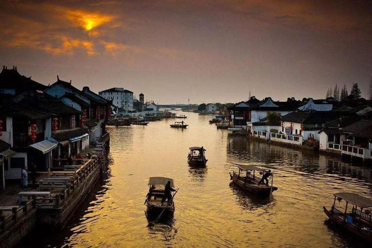 two boats in a river with houses and buildings