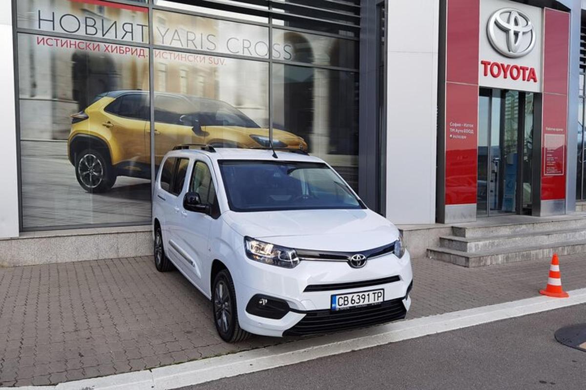 a small white car parked in front of a store