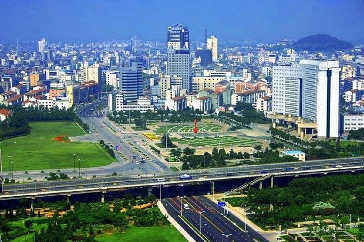 a view of a city with a bridge and a freeway