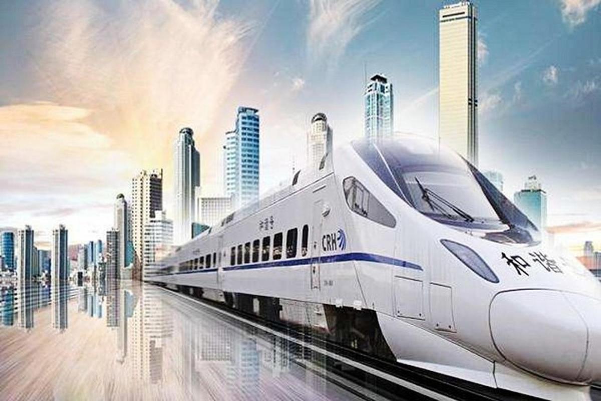 a white train on tracks in front of a city