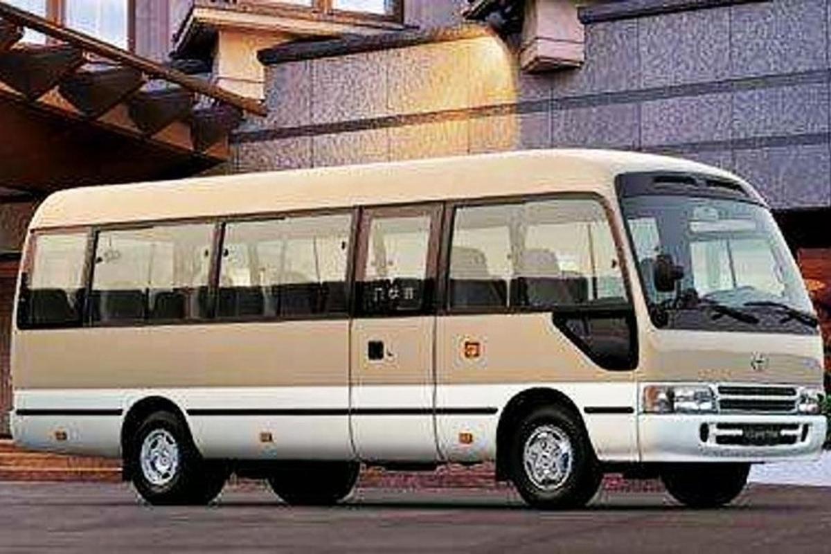 a white bus parked in front of a building