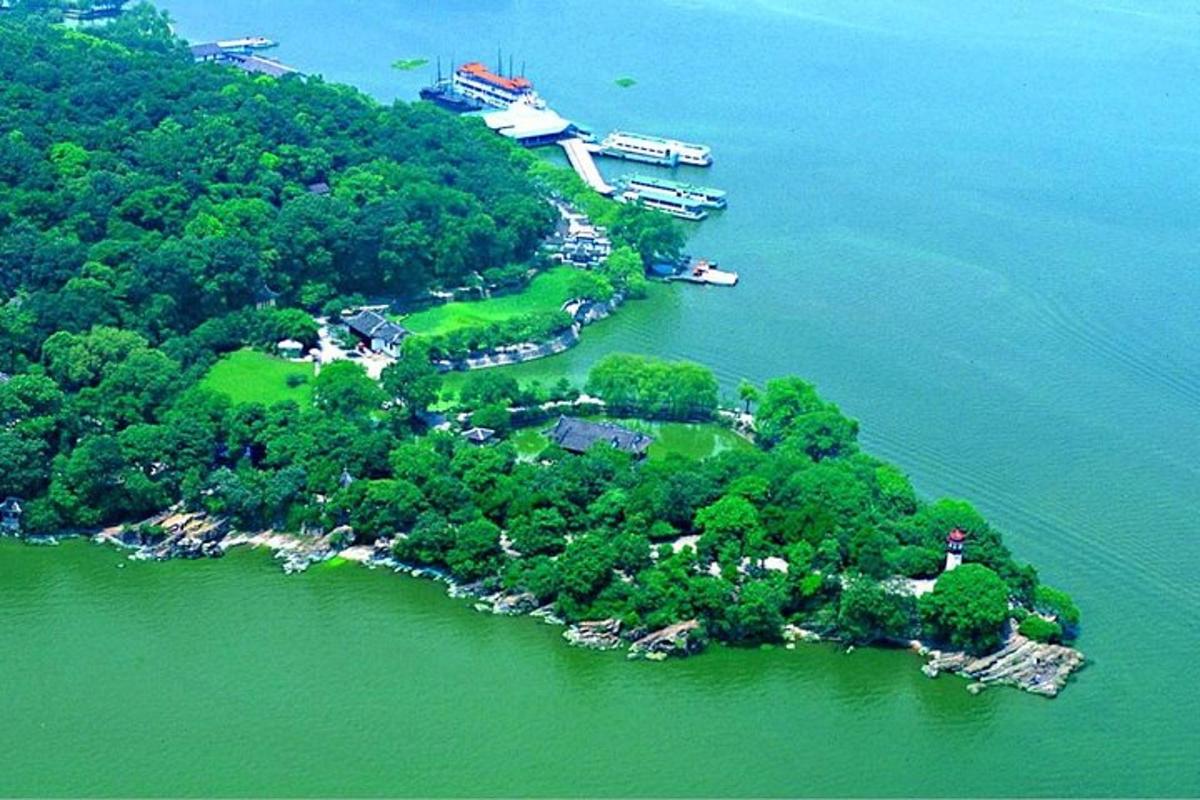 an island in the water with a boat in it