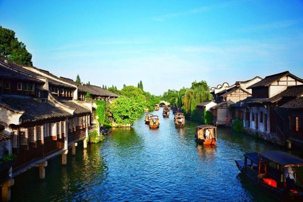 a group of boats in a river with buildings