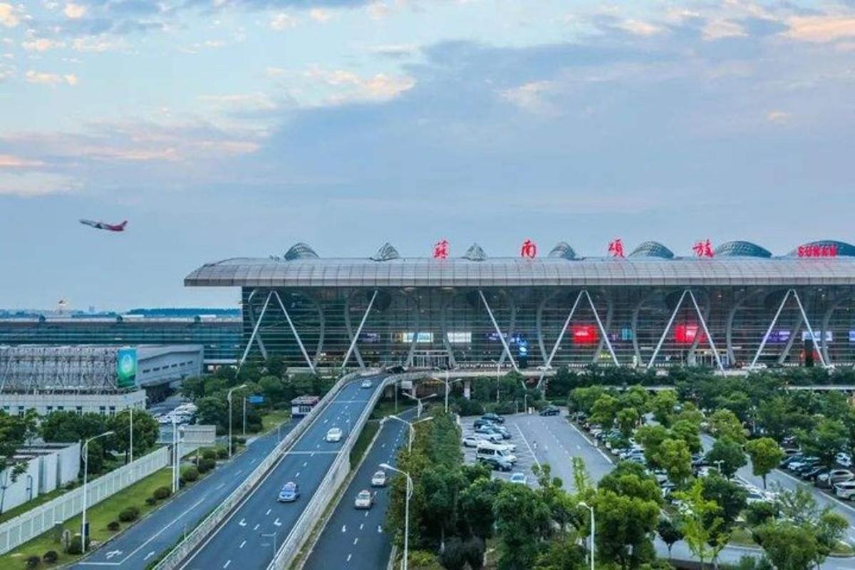 a large stadium with a highway in front of it