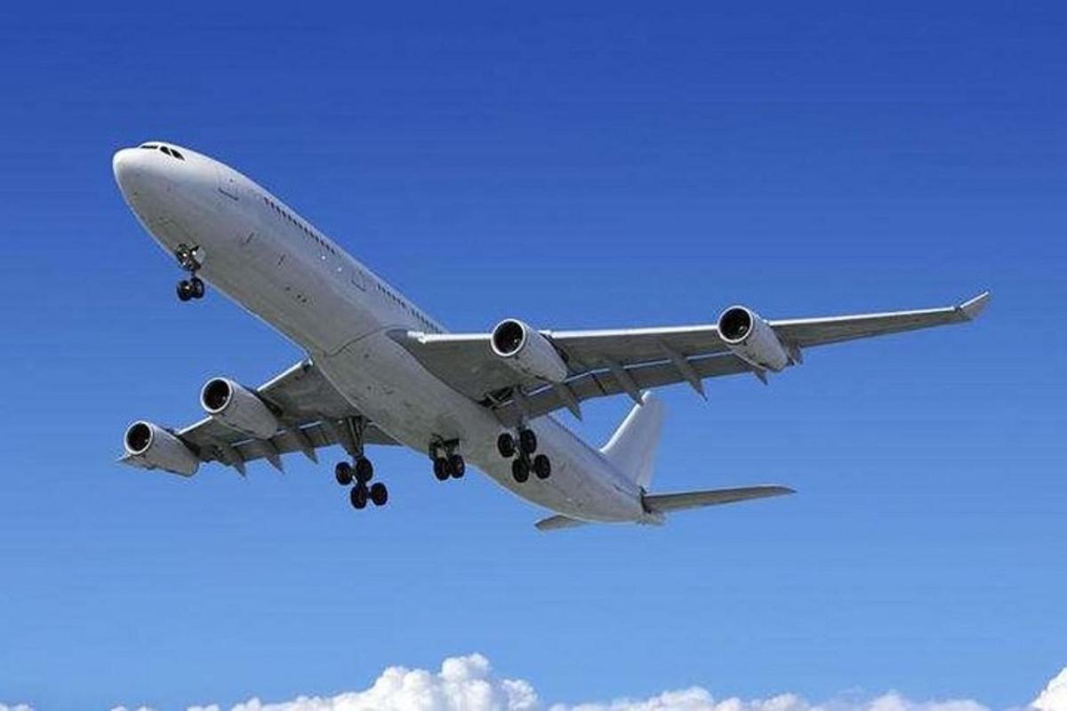 an airplane is flying in the blue sky
