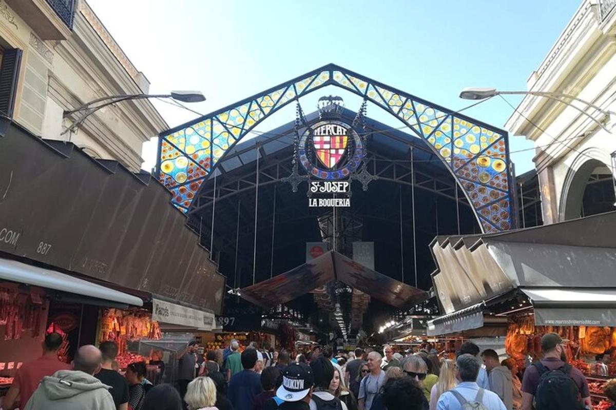 a crowd of people in a market with a building