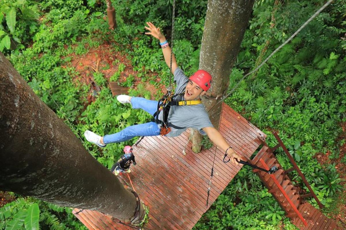 a person on a zip line in the jungle