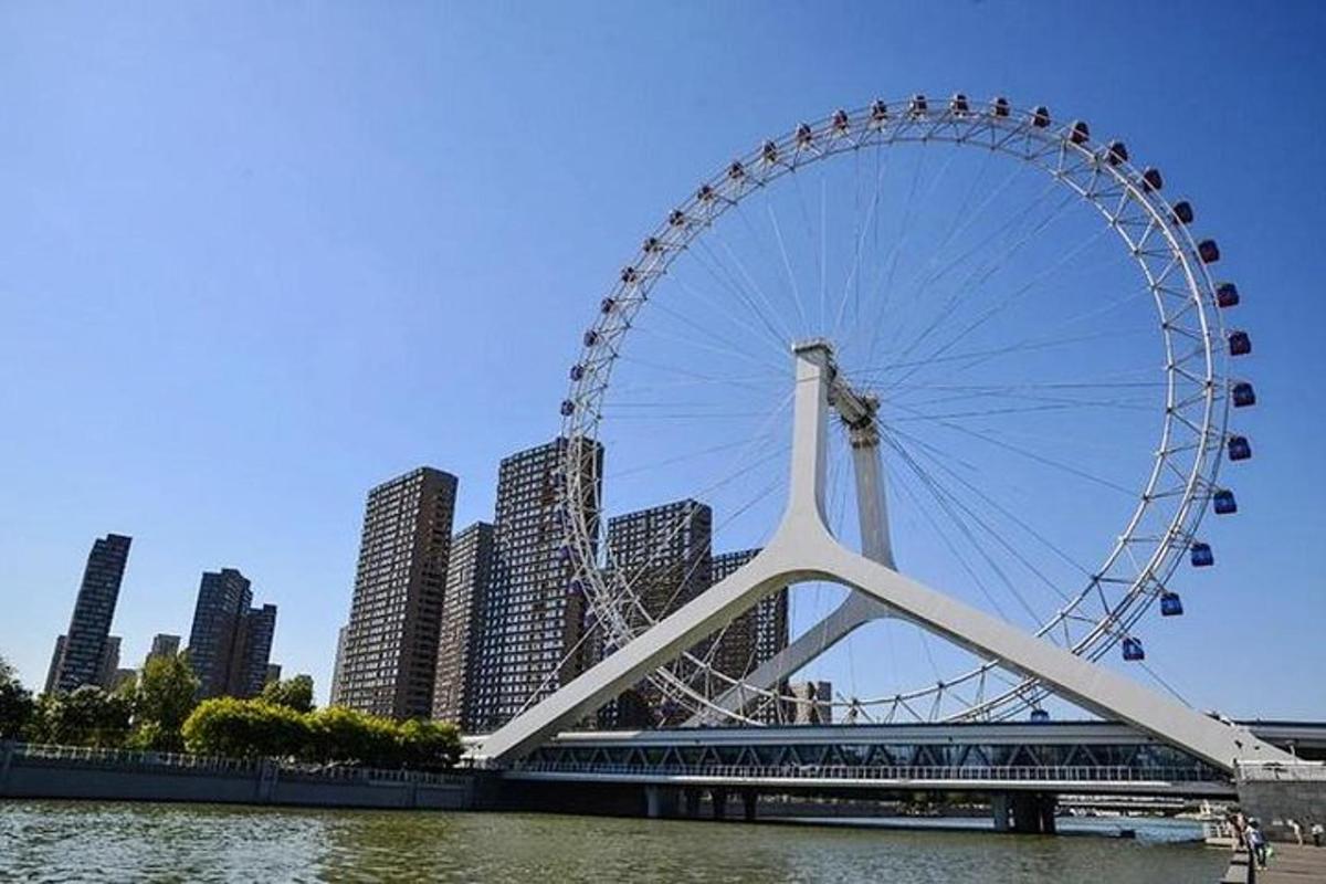 a large ferris wheel on a bridge over a river