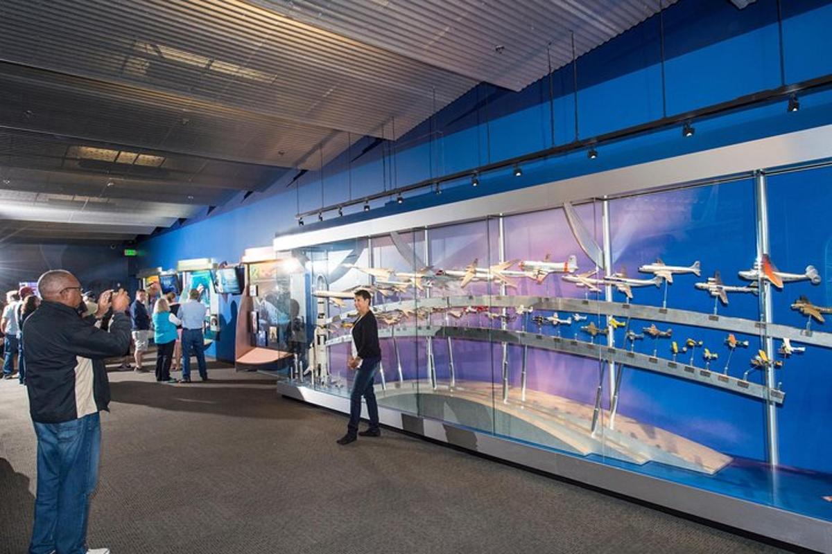 a group of people looking at a display in a museum