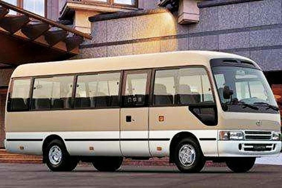 a white bus parked in front of a building