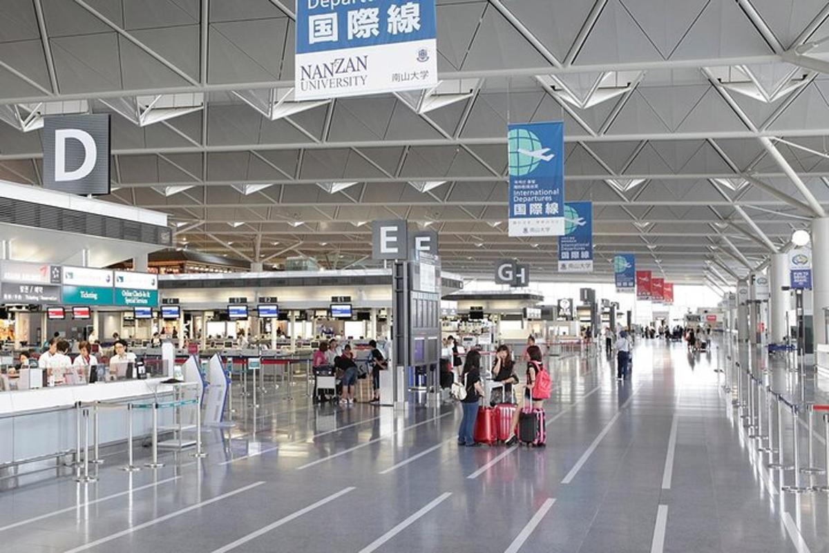 a group of people walking around an airport with luggage