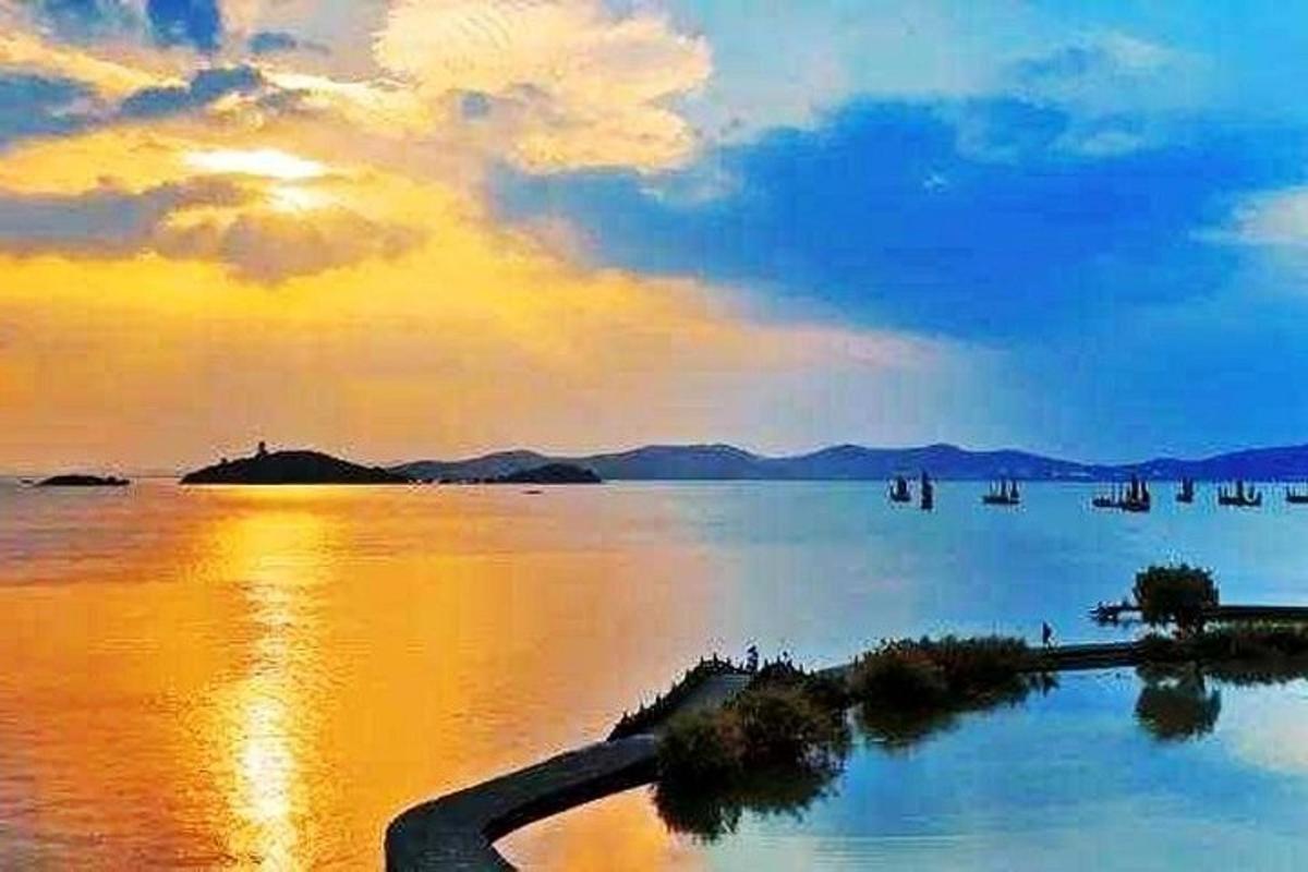 a view of a large body of water at sunset