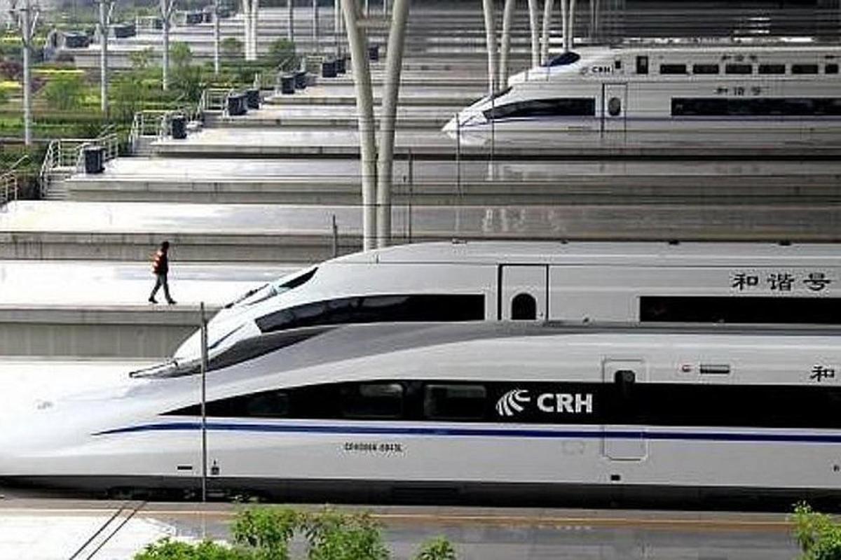 two bullet trains are parked next to each other