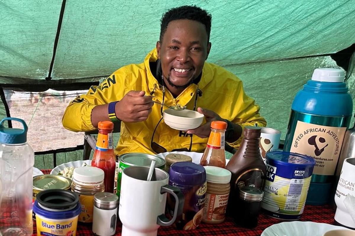 a man sitting at a table with a bowl of food
